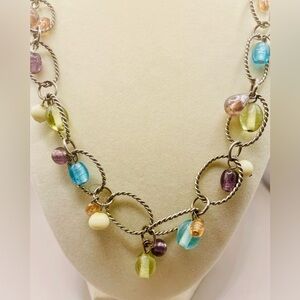 Long silver necklace with ovals inlaid with multicolor beads and crystals